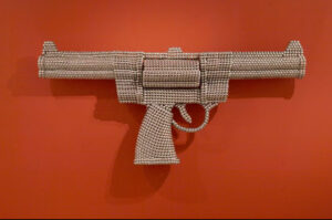 Valay Shende | Gun of Counter Revolution | 2007 | <div>Nickel Plated & Embossed MS metal disks<|div> | H 45 x W 97.5 x D 13 Inches