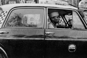 Pablo Bartholomew | Taxi Driver with passengers, Bombay . | Circa 1979 | Archival Pigment Print Ed:1|10 | 16 x 24 inches