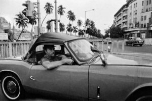 Pablo Bartholomew | Man in a racing car, Bombay | Circa 1979 | Archival Pigment Print Ed 1|10 | 16 x 24 Inches